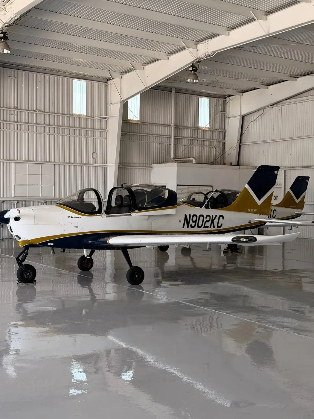 Two CFII P-Mentors parked in the hangar