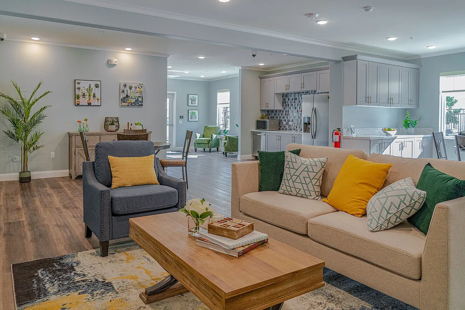 The clubhouse at Turtle Creek: sofas and armchairs in an open lounge next to a full kitchen